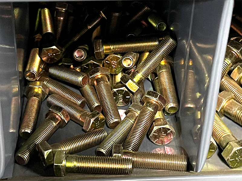 gold bolts in a plastic box